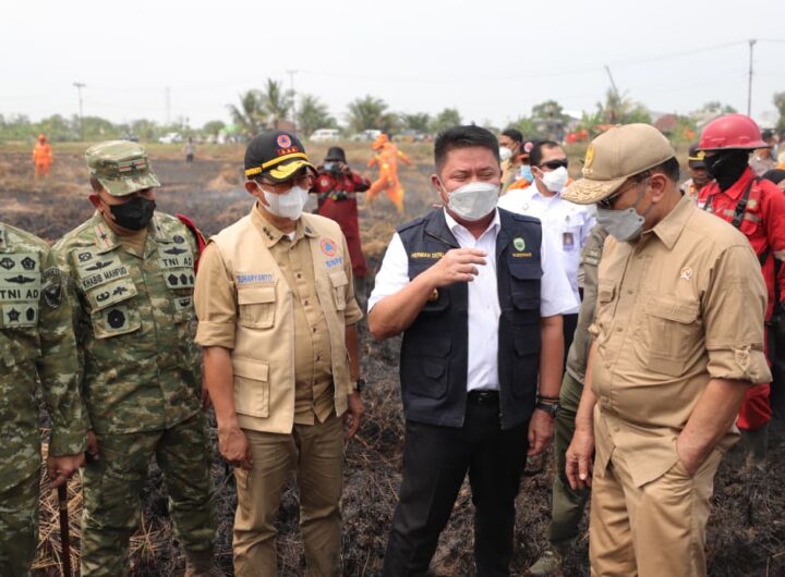 Kepala BNPB Letjen TNI Dr. Suharyanto bersama Menko Polkam Jenderal TNI (Purn.) Djamari Chaniago meninjau langsung operasi pemadaman karhutla di Kertapati, Palembang.